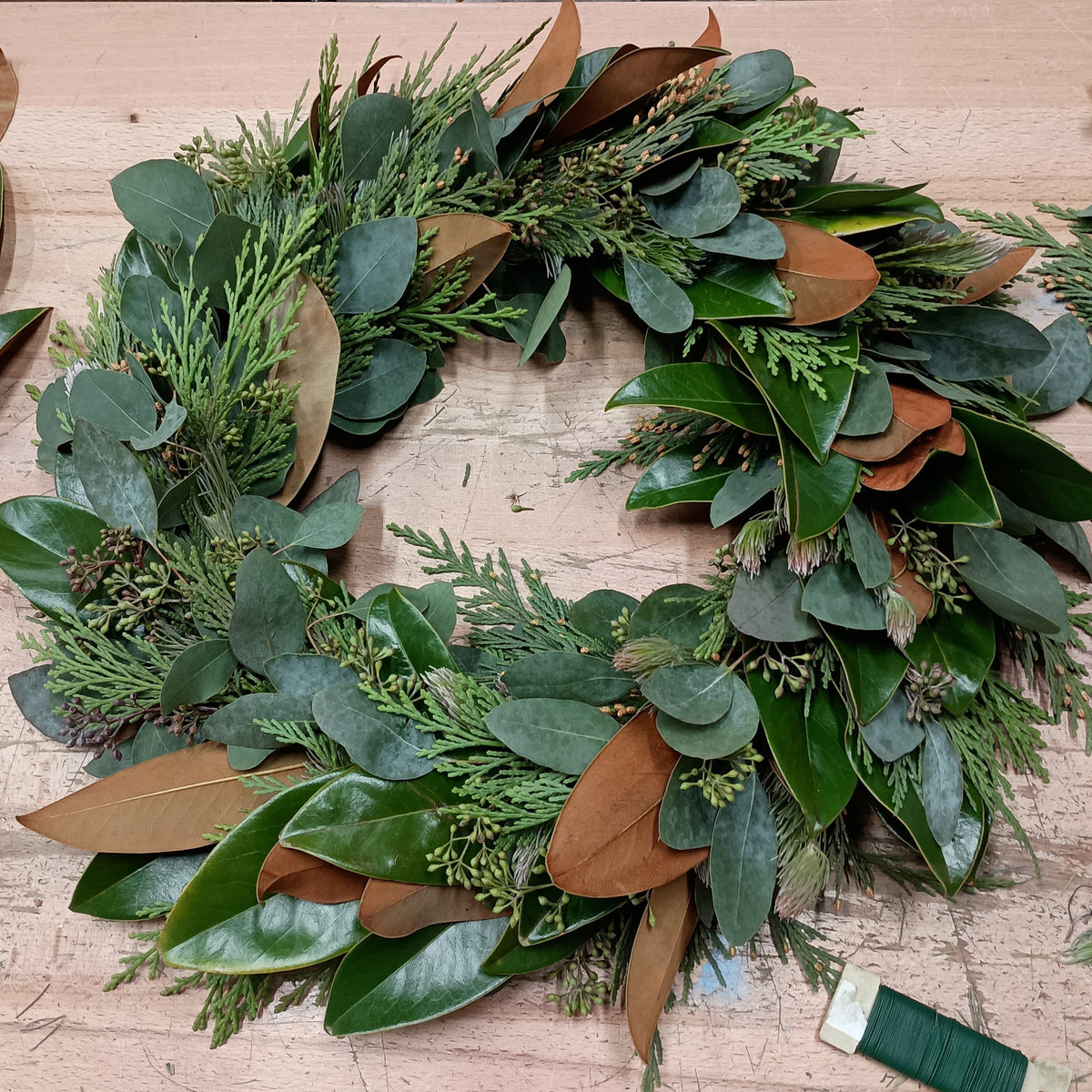 Fresh greenery wreath with eucalyptus and magnolia leaves handmade at Lizzie Bee’s Flower Shoppe in Richardson, Texas.