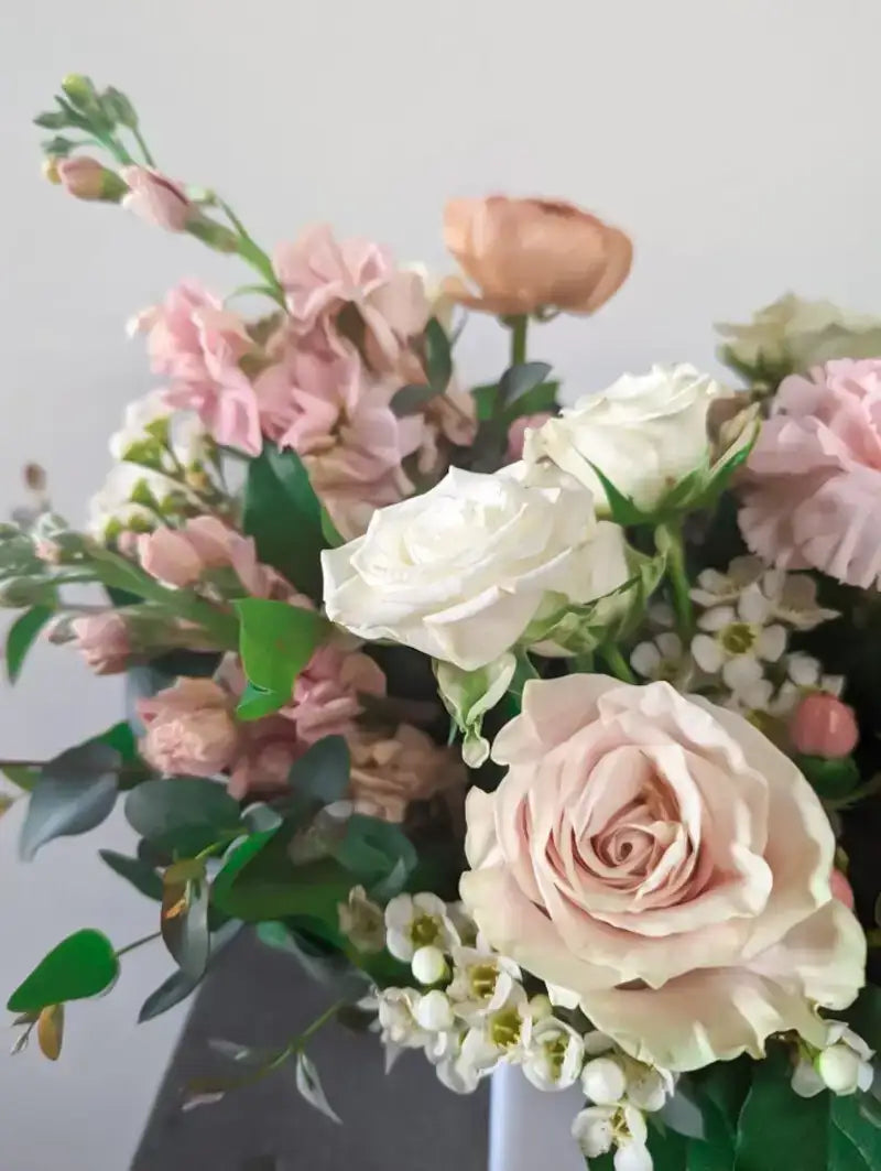 Fresh pink and white floral arrangement with roses and greenery from a Richardson, TX florist