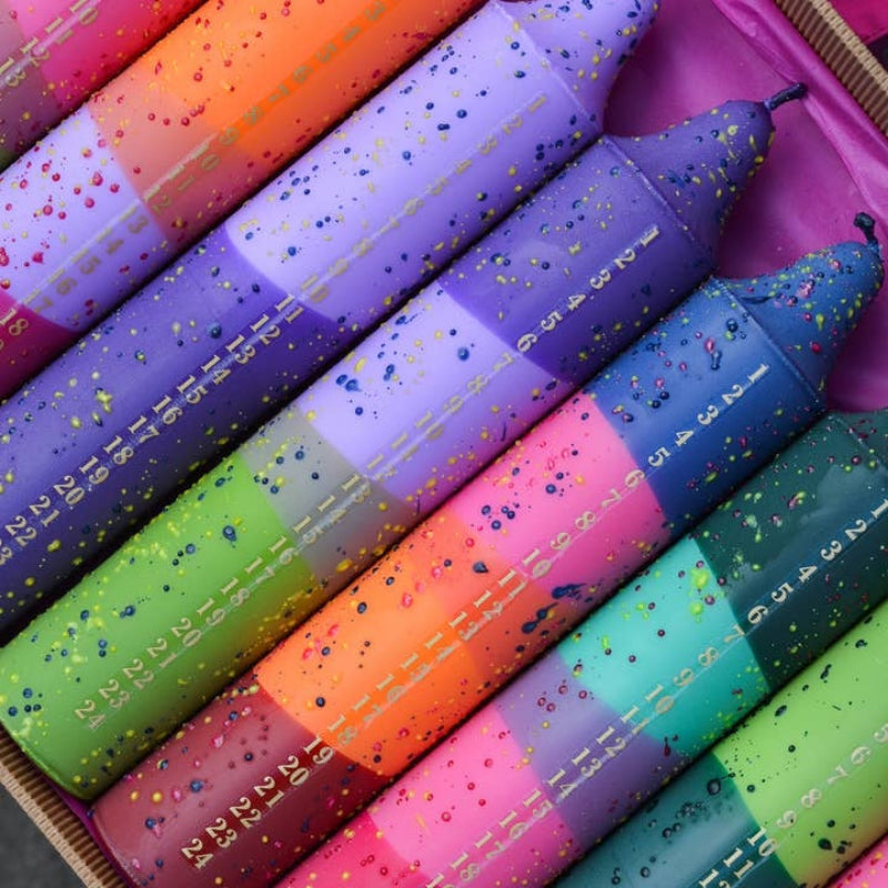 multi-color advent candles with numbers down the side to burn a section each day for countdown to christmas