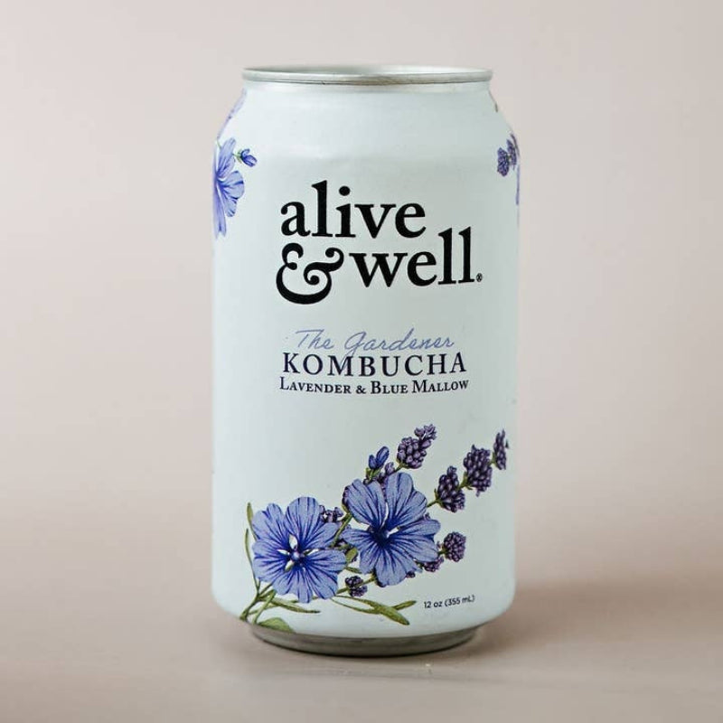 A 12 oz aluminum can of 'alive & well.' Kombucha, specifically 'The Gardener' Lavender & Blue Willow flavor, featuring a white label decorated with blue flowers and purple lavender illustrations on a soft beige background.