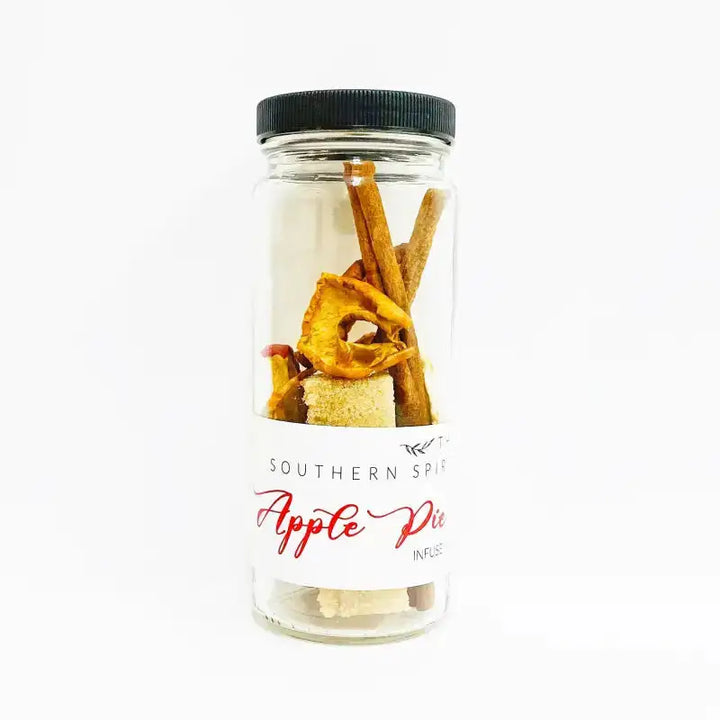 Glass jar with cinnamon sticks and a label reading 'Southern Spice Apple Pie' on a white background