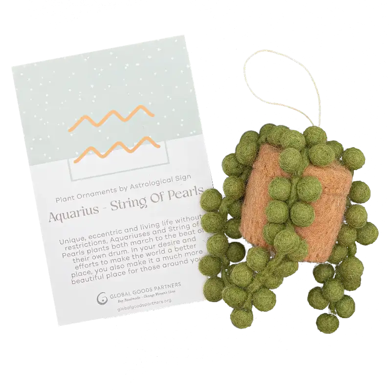 Decorative ornament with green spherical elements and a card on a white background