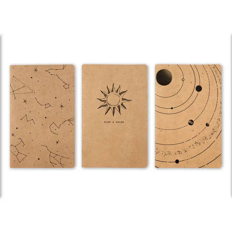 Three brown notebooks with celestial designs on a white background