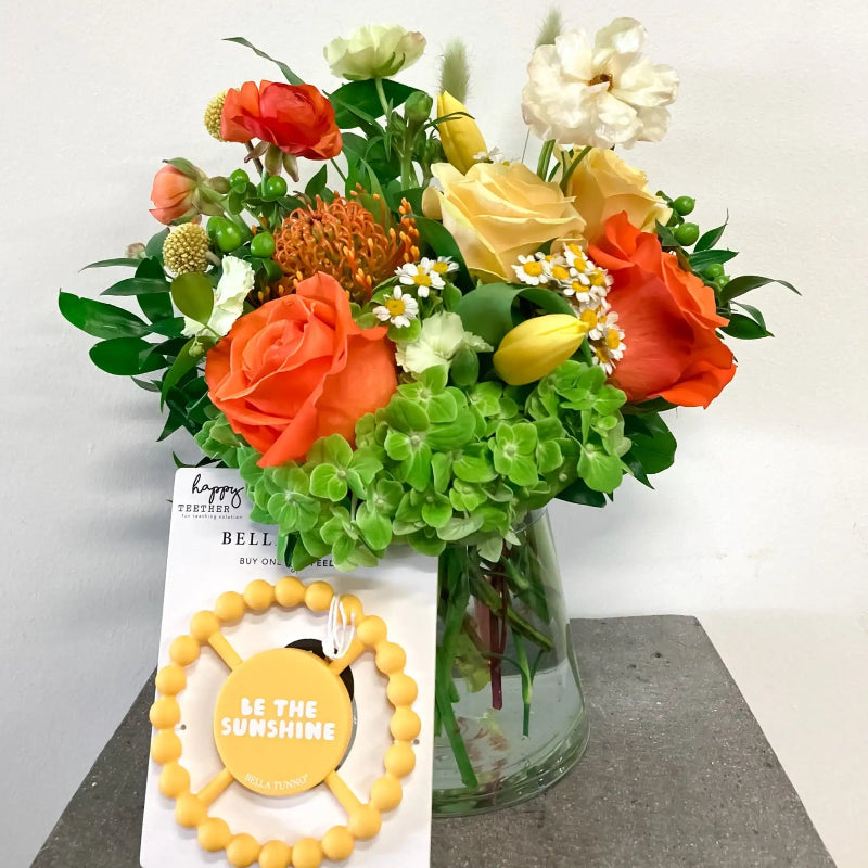 Bouquet of flowers with a yellow bracelet on a white background