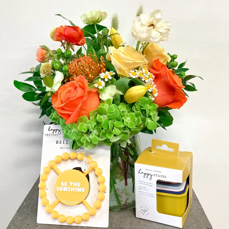 Bouquet of flowers with a yellow bracelet and packaging on a white background