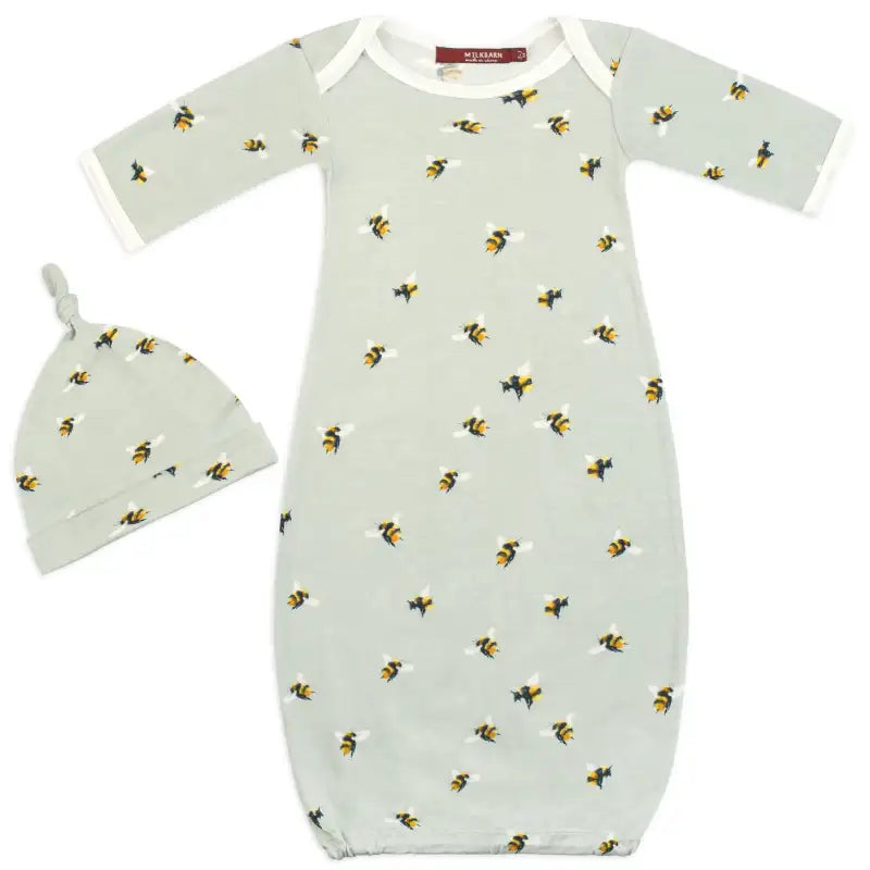 Baby gown and hat set with bee pattern on a white background