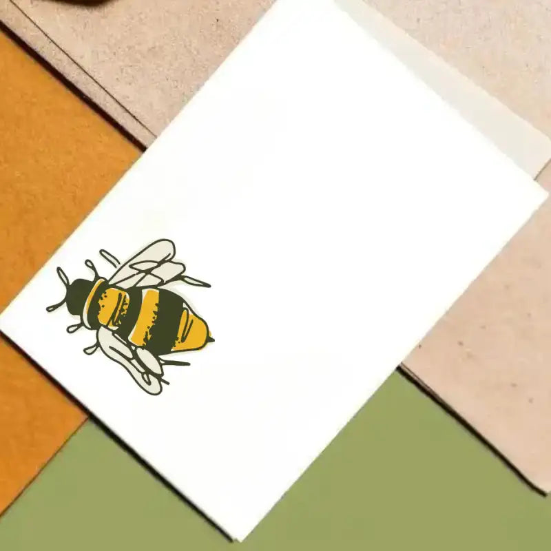 White card with a bee illustration on a colorful geometric background
