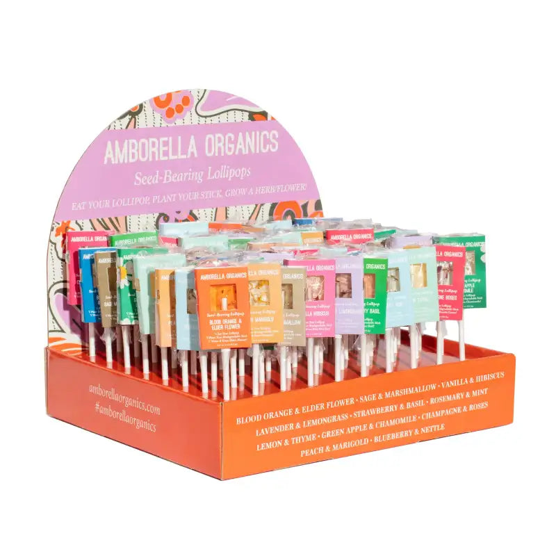 Display of Amborella Organics seed-harvest lollipops with colorful packaging.