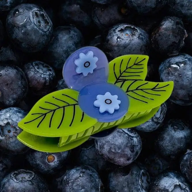 Decorative blueberry hair claw on a bed of blueberries