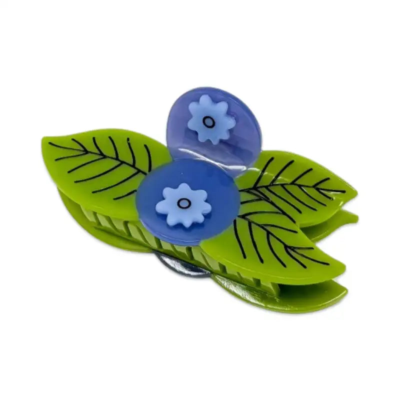 Green leaf-shaped clips with blue flower centers on a white background