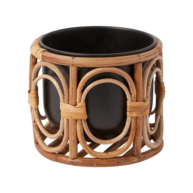 Rattan plant pot with black interior on a white background