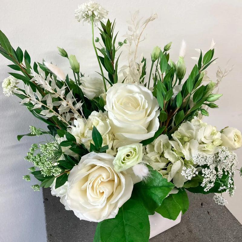 Bouquet of white and green flowers on a light gray background