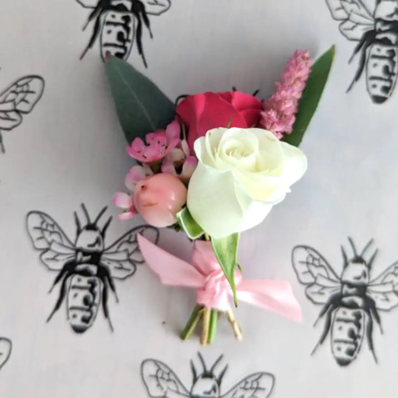 Floral arrangement with pink and white flowers on a background with bee illustrations