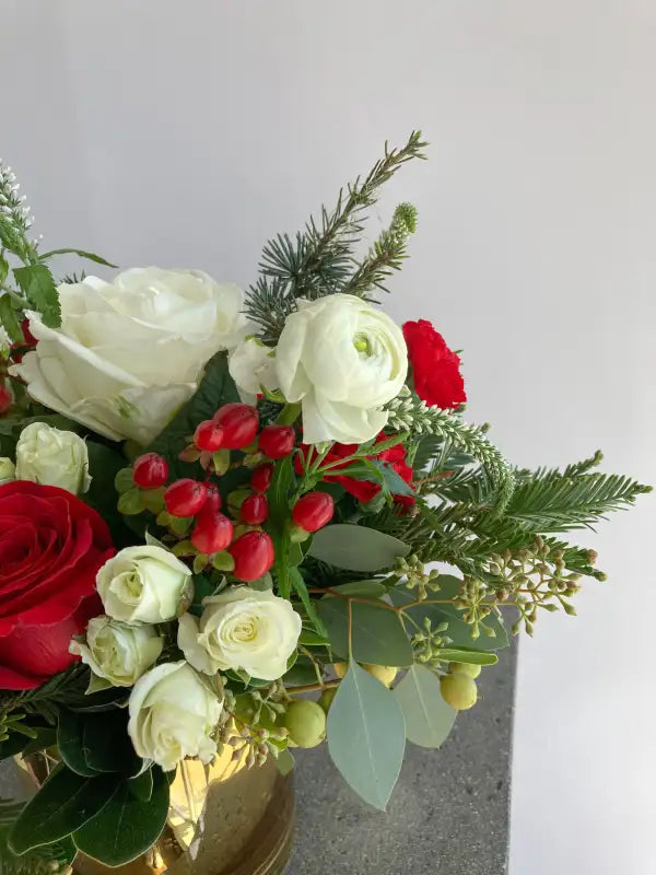 Bouquet of red, white, and green flowers on a light gray background