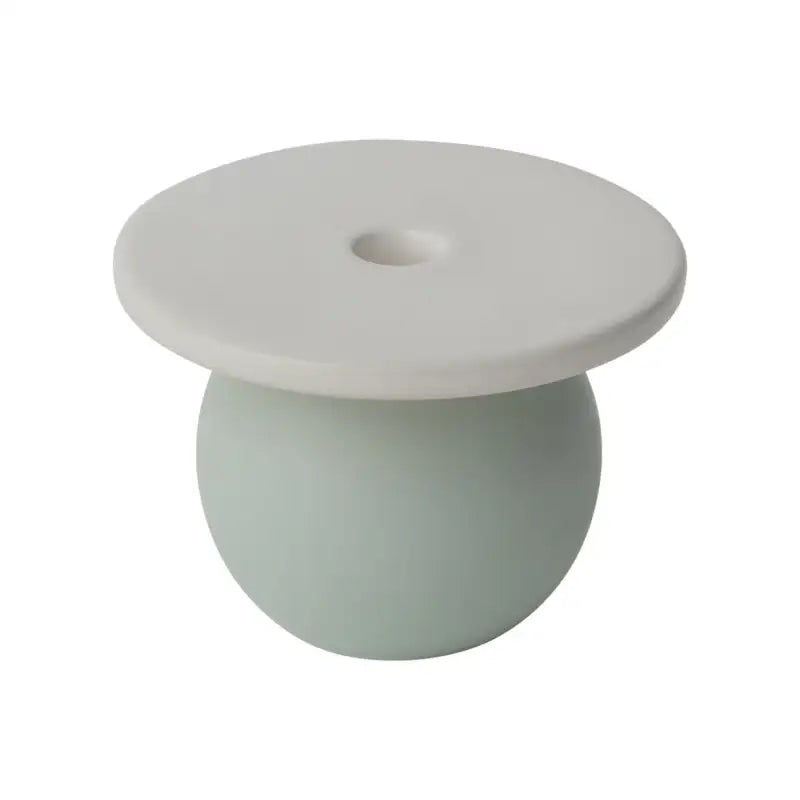Two-tone ceramic vase with a white top and light green bottom on a white background
