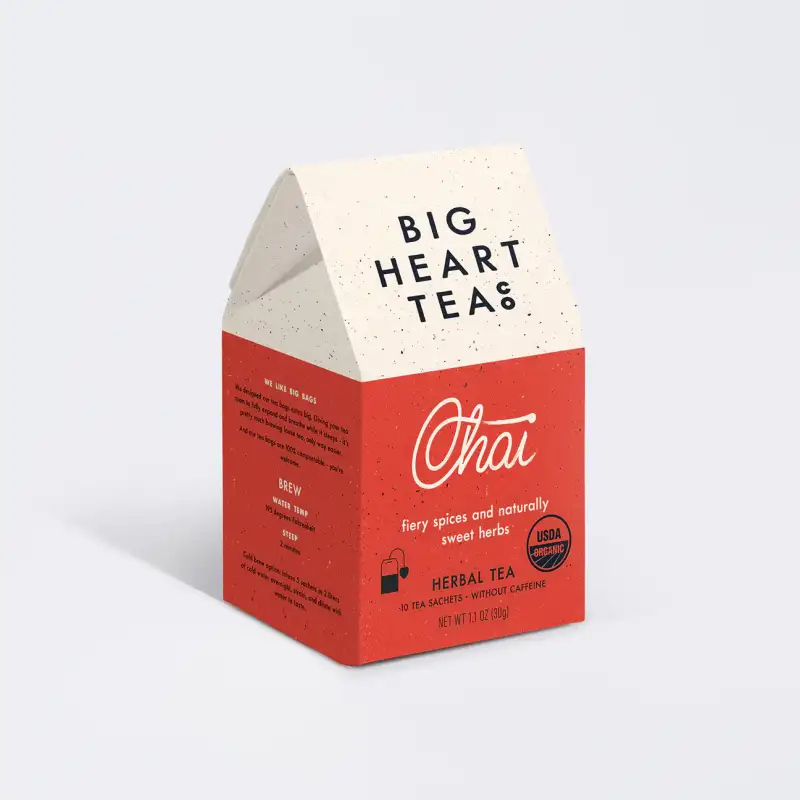 Red and white box of Big Heart Teas Chai herbal tea on a light gray background
