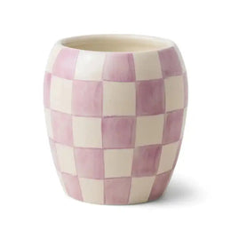 Checkered ceramic cup with pink and beige pattern on a white background