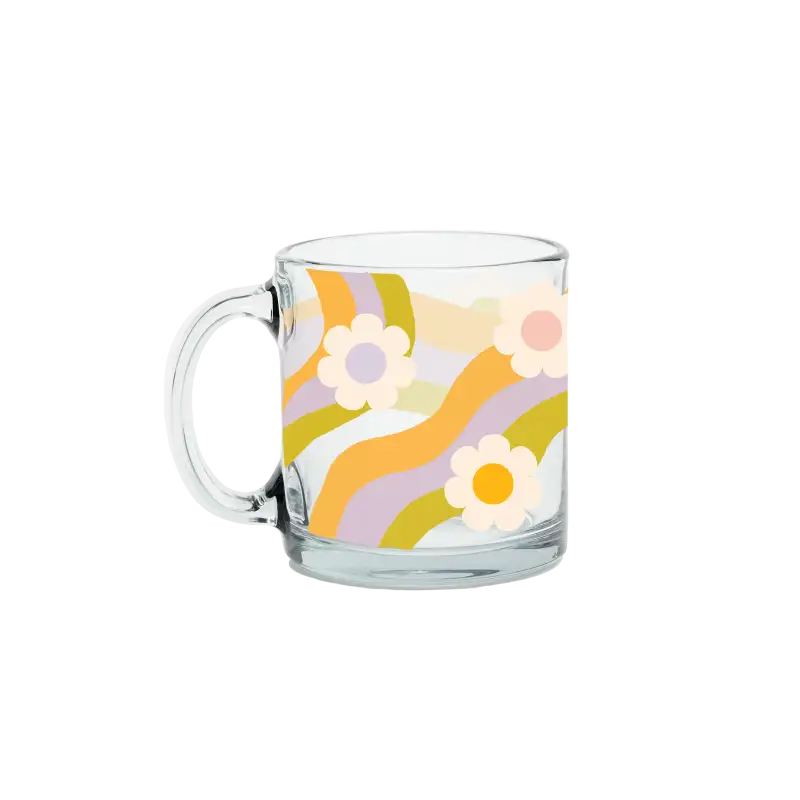 Clear glass mug with floral design on a white background