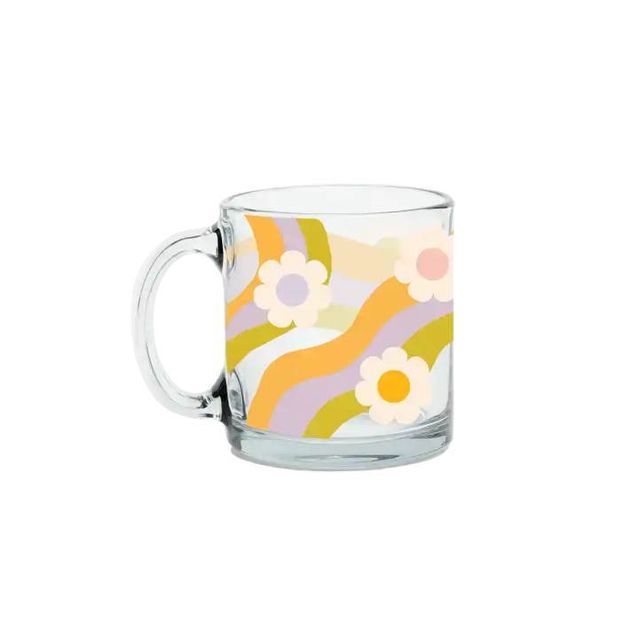 Clear glass mug with floral design on a white background
