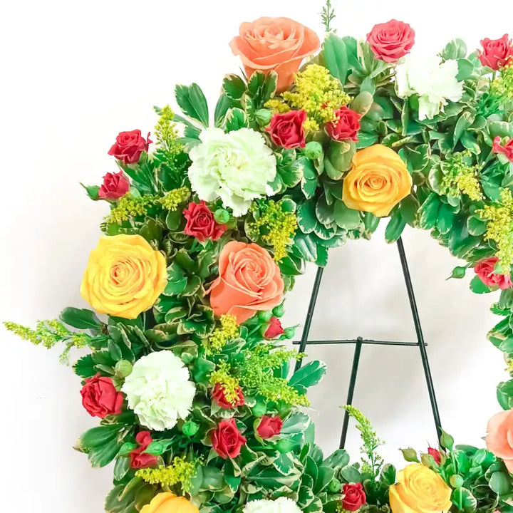 Floral wreath with colorful flowers on a white background