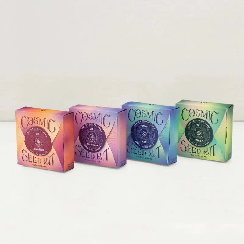 Four colorful 'Cosmic Seed Kit' boxes on a white background
