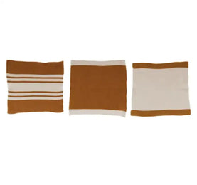 Three rectangular cushions with striped patterns on a white background