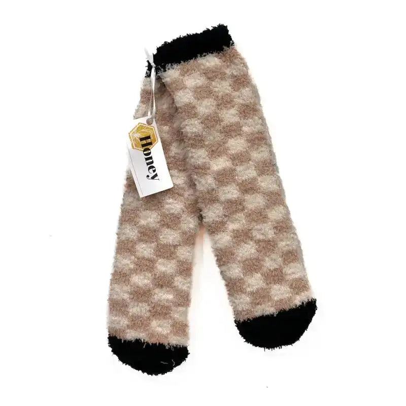 Plaid patterned leg warmers with a 'Honey' tag on a white background