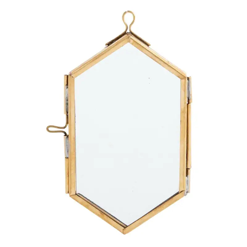 Hexagonal mirror with gold frame on a white background