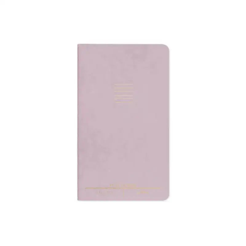 Pink notebook with gold accents on a white background