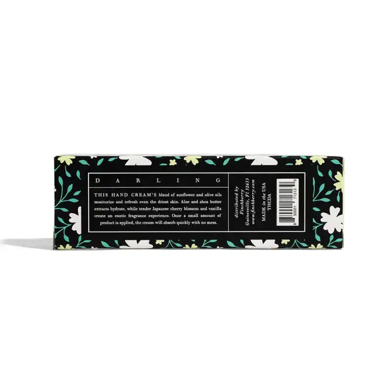 Hand cream packaging with floral design and text on a white background
