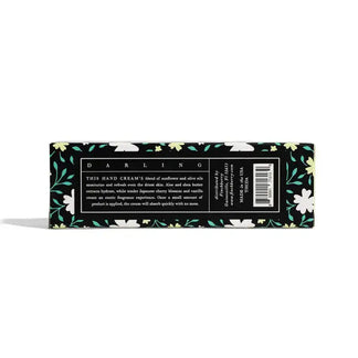 Hand cream packaging with floral design and text on a white background