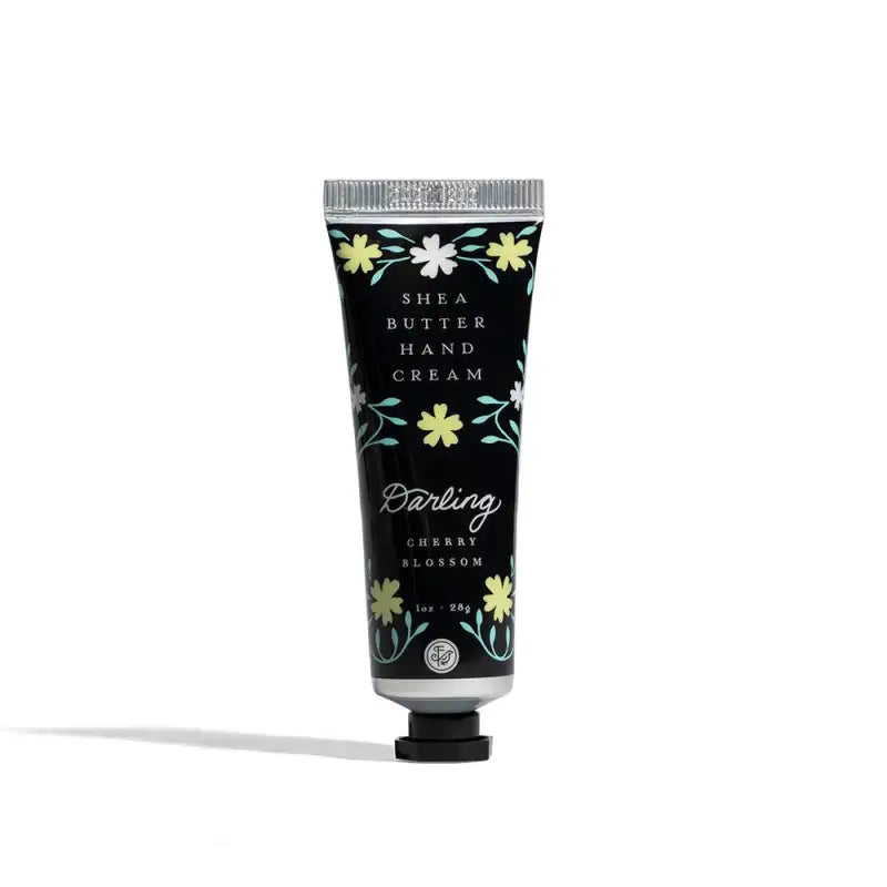 Shea butter hand cream tube with floral design on a white background