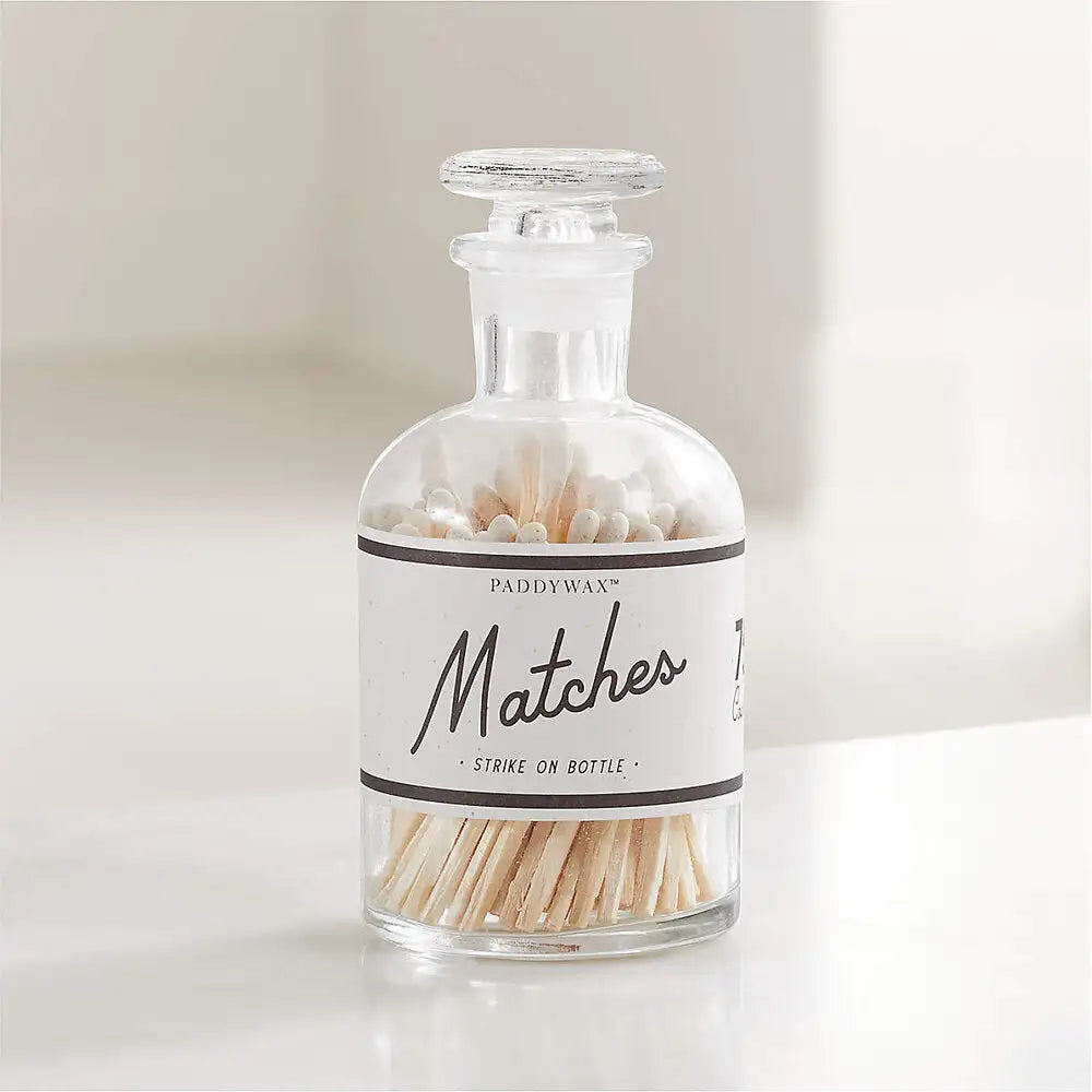 Glass jar with matches on a white background