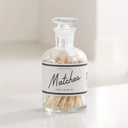 Glass jar with matches on a white background