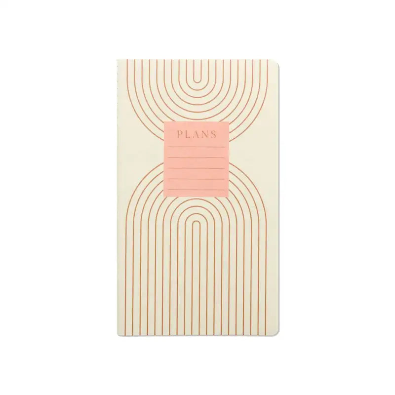 Notebook with geometric design and pink label on a white background