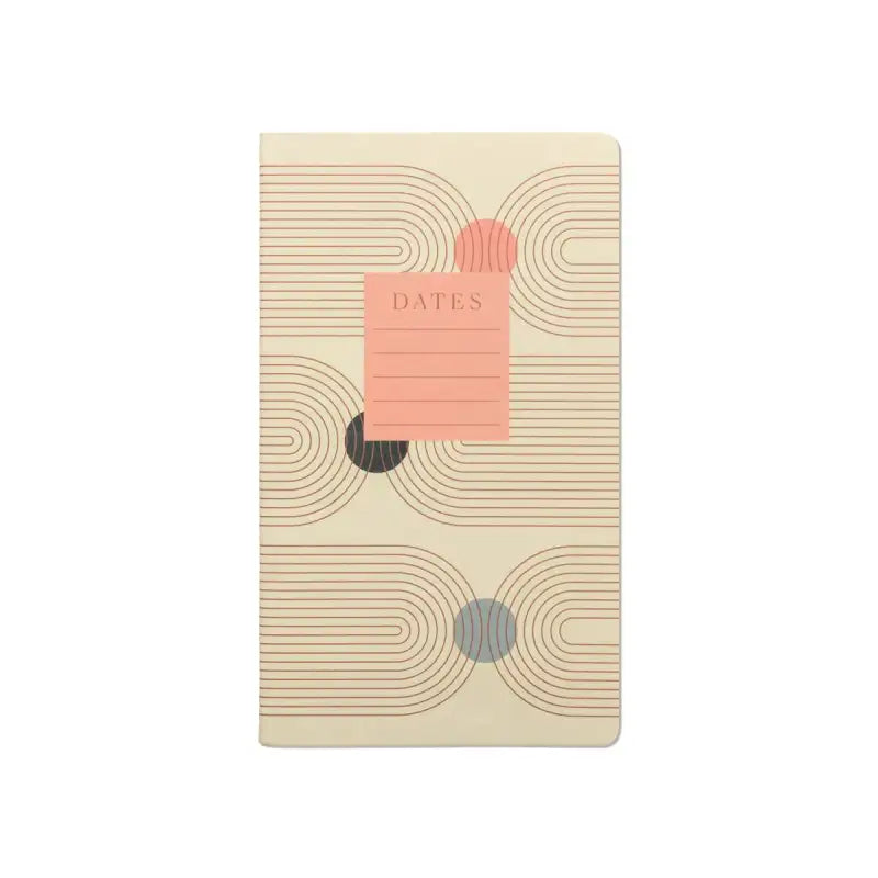 Beige notebook with circular patterns and a pink label on a white background
