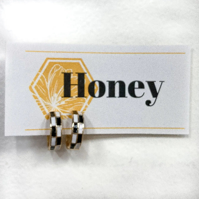 Pair of gold hoop earrings on a card with 'Honey' text and honeycomb design.