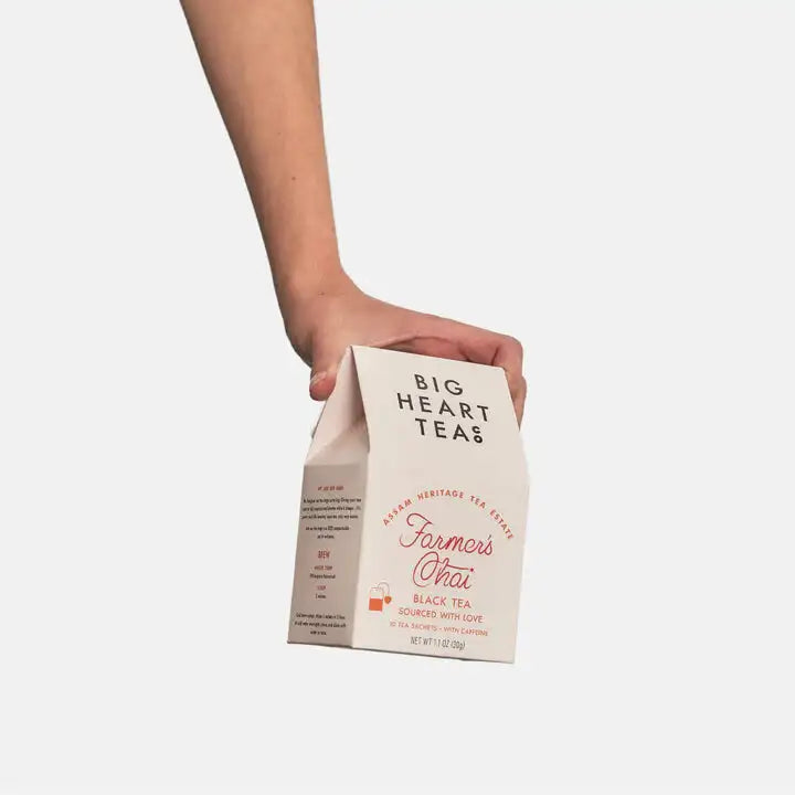 Person holding a Big Heart Teas package on a white background