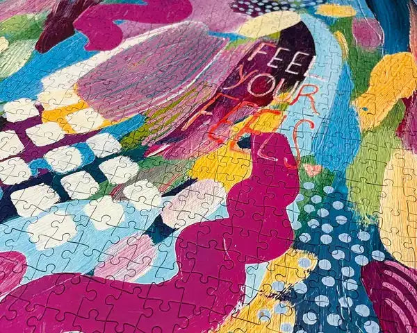 Colorful puzzle with abstract design and text 'FEEL YOUR FLOW' on a multicolored background