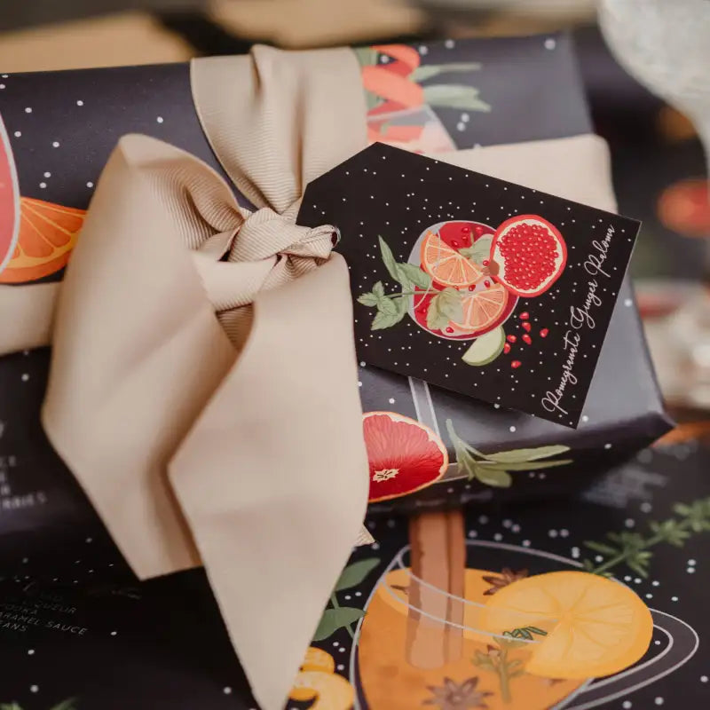 Gift box with decorative label featuring fruit illustrations on a dark background.