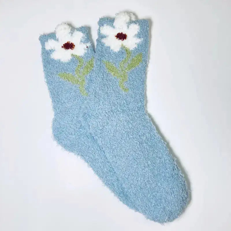 Light blue sock with white flower design on a white background