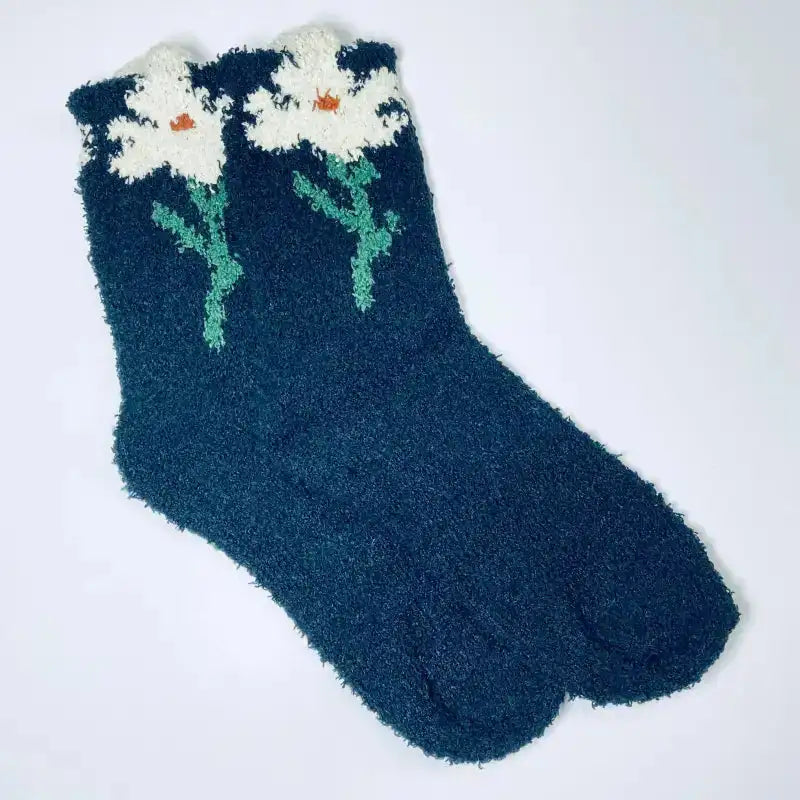 Blue fuzzy sock with white floral design on a white background
