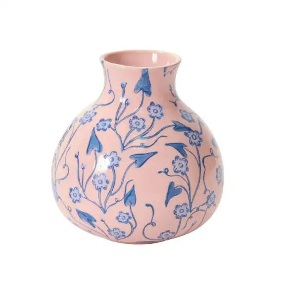 Pink vase with blue floral patterns on a white background