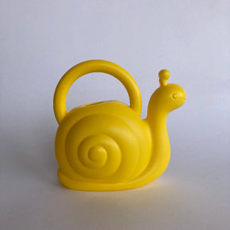 Yellow snail-shaped watering can on a light gray background