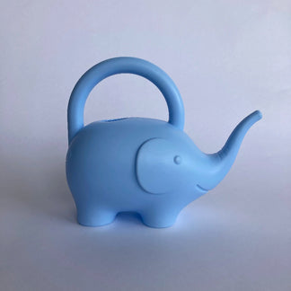 Blue elephant-shaped watering can on a light gray background
