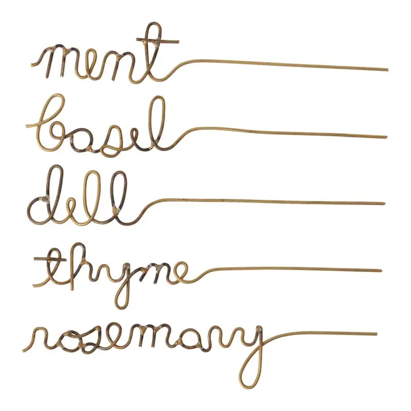 Set of gold herb markers with cursive text on a white background