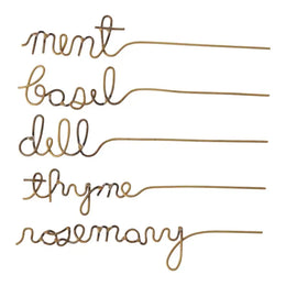 Set of gold herb markers with cursive text on a white background