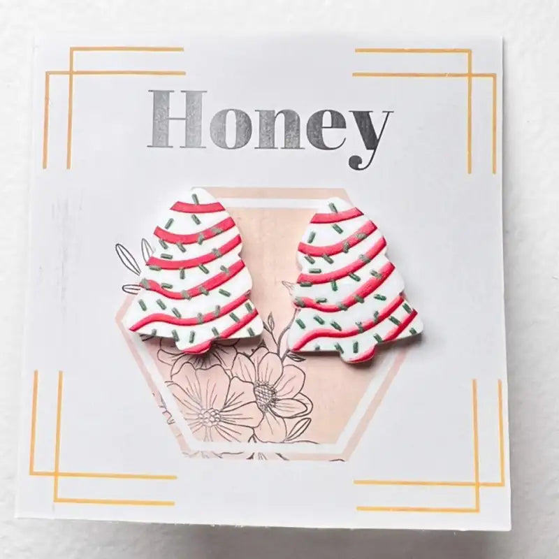 Product packaging with 'Honey' text and floral design on a white background