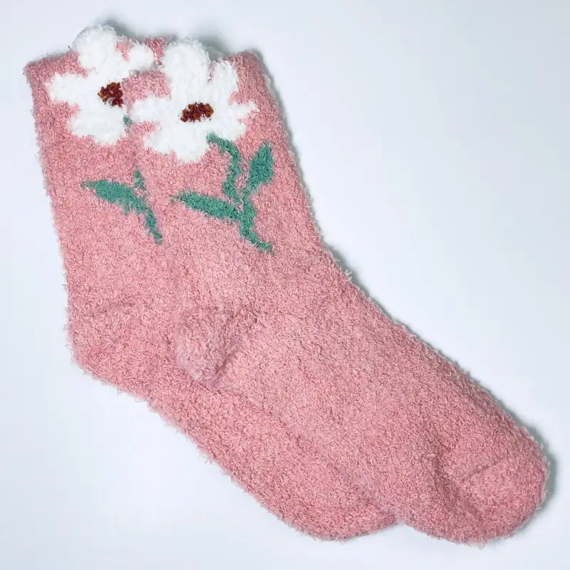 Pink fuzzy sock with a floral design on a white background