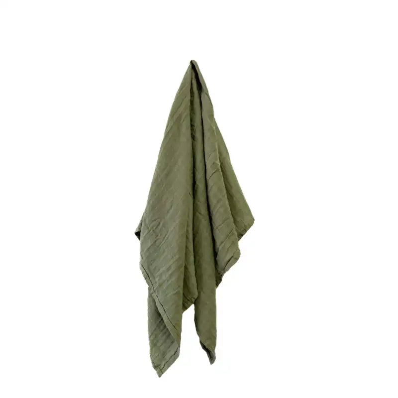 Green towel draped over a white background